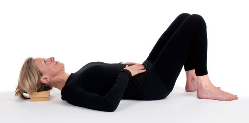 Person lying down in semi supine position (Alexander Technique)
