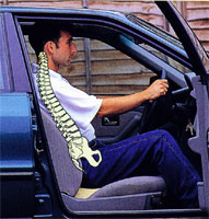 Man using wedge-shaped posture cushion in car benefits from improved posture
