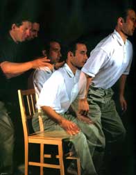 Man learning how to rise from a chair without tensing with the help of an Alexander teacher