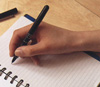 Person writing in a notebook