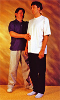The teacher helps this man to lengthen all the way from his feet to the top of his head