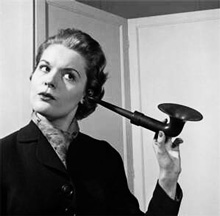 Woman listening with ear horn