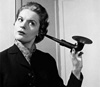 Woman listening with ear horn