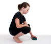 Girl picking up an object with good posture