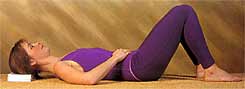 Woman lying down in the way recommended by the Alexander Technique
