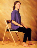 Girl using wedge-shaped posture cushion benefits from improved posture