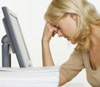 Woman at computer looking stressed